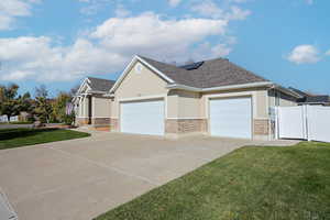 View of home's exterior with a lawn and a garage