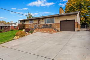 Single story home featuring a front lawn and a garage and driveway.  Lots of off street parking.