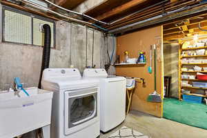 Laundry room featuring sink and plenty of storage