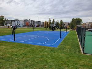 View of sport court featuring a lawn