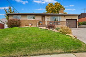 Single story home featuring a front lawn and a garage at 4220 Jefferson Ave. South Ogden.