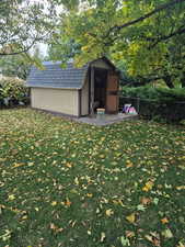 View of outdoor structure with a yard