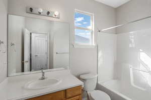 Full bathroom featuring vanity, bathing tub / shower combination, and toilet