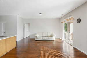 Unfurnished living room with dark wood-type flooring