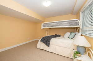 Carpeted bedroom featuring a textured ceiling