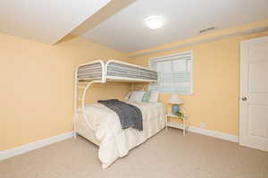 Bedroom featuring a textured ceiling and carpet flooring