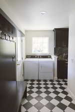 Washroom featuring washer and dryer and cabinets