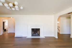 Unfurnished living room featuring dark hardwood / wood-style flooring