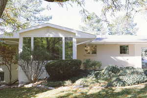 View of property exterior with a sunroom