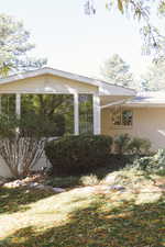 View of property exterior featuring a sunroom