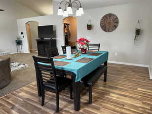 Dining area with a chandelier and dark hardwood / wood-style flooring