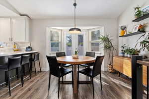 Dining room featuring dark wood-type flooring