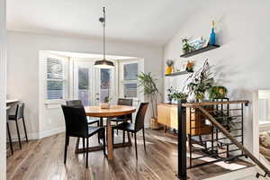 Dining area featuring hardwood / wood-style flooring and vaulted ceiling