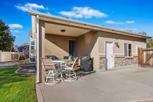 Rear view of house with a patio area and a yard