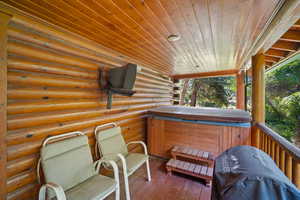 Wooden deck featuring a hot tub