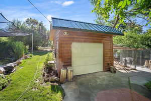 Garage featuring a lawn