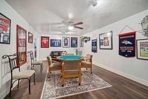 Playroom featuring a textured ceiling, wood-type flooring, and ceiling fan