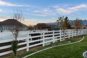 Upgraded vinyl fencing currently set up for horses or other animals; this space could be used for an expanded garden space