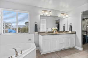 Grand Master Bathroom features a soaking tub and shower; adjacent large walk in closet