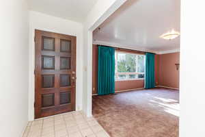 Entryway featuring light colored carpet