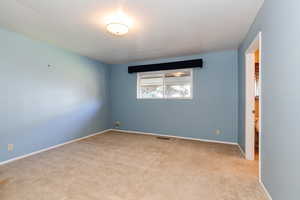 Unfurnished room with light colored carpet