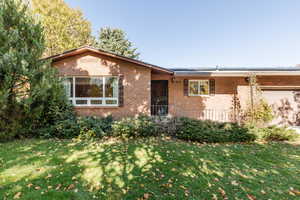 Ranch-style home featuring a front yard