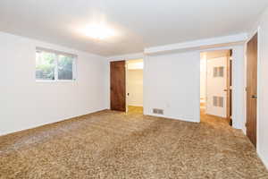 Unfurnished bedroom featuring a closet, carpet floors, and a walk in closet