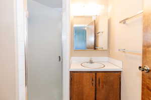 Bathroom featuring vanity and a shower with shower door