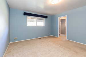 Unfurnished room with light colored carpet