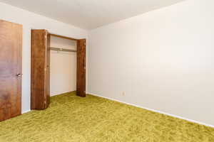 Unfurnished bedroom with a closet and carpet