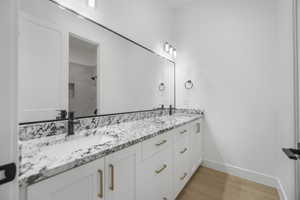 Bathroom featuring vanity, hardwood / wood-style flooring, and tiled shower