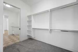 Walk in closet featuring carpet flooring