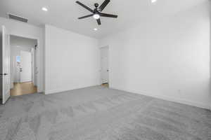 Carpeted spare room featuring ceiling fan