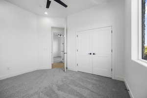 Unfurnished bedroom featuring a closet, ceiling fan, and carpet