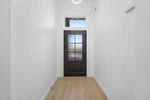 Doorway to outside with light wood-type flooring