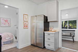 Kitchen with stainless steel refrigerator and light hardwood / wood-style flooring