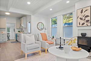 Living area with beamed ceiling, light hardwood / wood-style flooring, and plenty of natural light