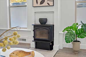 Room details featuring a wood stove and wood-type flooring