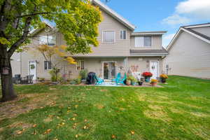 Back of property featuring a patio and a yard