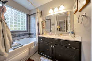 Bathroom featuring vanity and shower / tub combo with curtain