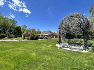 Gazebo with swing looking toward pool house