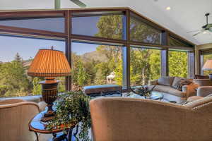 Living room featuring, high vaulted ceiling, ceiling fan, and view of Pine Valley Mountains