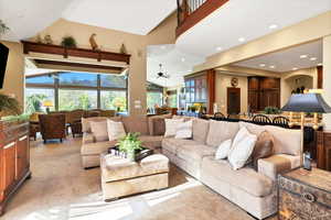 Living room off kitchen featuring French doors, light carpet, a healthy amount of sunlight, and a fireplace