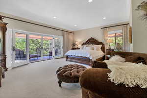 Primary bedroom with French doors leading to balcony,  and ornamental molding