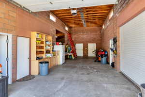 Barn featuring a garage door opener and refrigerator