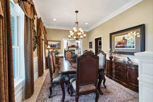 Dining space with ornamental molding and a chandelier