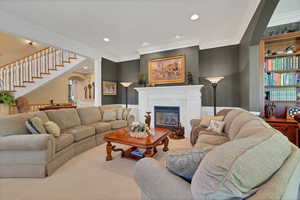 Living room off entrance  featuring ornamental molding, fireplace and built-in bookshelf