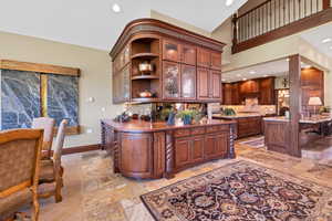 Dining space off kitchen and living room high vaulted ceiling and ceiling fan with notable chandelier