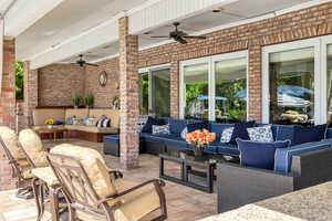 View of patio featuring outdoor lounge area and ceiling fan off pool