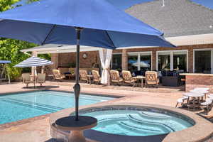 View of pool with a patio, an outdoor living space, and an in ground hot tub